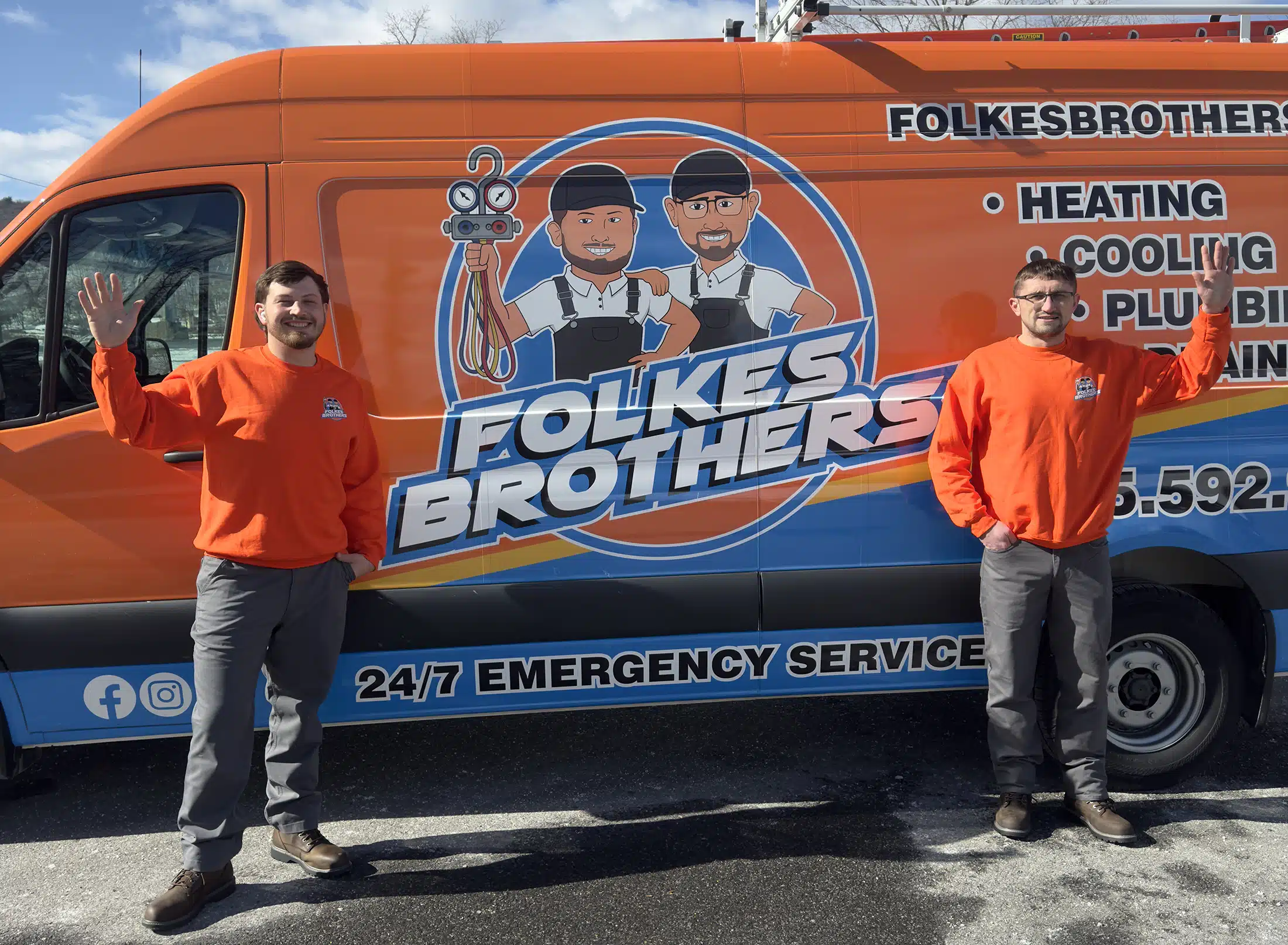 The Folkes Brothers standing beside a work van in Hopewell Junction, NY